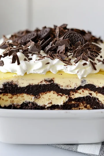 - Oreo cookies: 1 package (about 36 cookies), finely crushed - Unsalted butter: ½ cup, melted - Cream cheese: 8 oz, softened to room temperature - Powdered sugar: 1 cup - Whipped topping: 1 cup (like Cool Whip) - Instant chocolate pudding mix: 1 package (3.9 oz) - Cold milk: 2 cups - Additional whipped topping: 1 cup (for the final layer) - Garnish: Chocolate shavings or crushed Oreo cookies For the best flavor, use fresh cream cheese and high-quality whipped topping. If you want a fun twist, you can swap Oreo cookies for another chocolate cookie. This adds a unique taste while keeping it delicious. {{ingredient_image_2}} To start, grab a medium mixing bowl. Add 36 crushed Oreo cookies and ½ cup melted butter. Stir this mix until the crumbs are well-coated. Now, take your 9x13 inch baking dish and press the mixture firmly into the bottom. Make sure it’s even. This helps the crust hold together. You can use a flat-bottomed cup to pack it down. Once done, place the dish in the fridge. Let it chill while you prepare the next layers. Next, in a separate bowl, take 8 oz of softened cream cheese and 1 cup of powdered sugar. Beat them together using an electric mixer. Mix on medium speed until it’s creamy and smooth. Avoid over-mixing to keep it fluffy. Now, gently fold in 1 cup of whipped topping with a spatula. Be careful not to deflate the mix. Spread this cream cheese layer evenly on the chilled crust. This layer adds a rich, creamy taste. In another bowl, whisk together 1 package of instant chocolate pudding mix with 2 cups of cold milk. Whisk for 2-3 minutes until it thickens. This is key for a perfect pudding layer. Pour the thickened pudding over the cream cheese layer. Use a spatula to spread it evenly. This ensures every bite has that delightful chocolate flavor. Now, take the remaining 1 cup of whipped topping. Carefully spread it over the chocolate pudding layer. Use a spatula to smooth the top. A smooth finish looks great and makes serving easier. This layer adds a light, airy touch to your dessert. Cover your lasagna with plastic wrap and refrigerate for at least 4 hours. For the best flavor, chill it overnight. This helps the layers set properly. Before serving, add some fun garnishes! Sprinkle chocolate shavings or crushed Oreo cookies on top. This not only looks nice but adds a tasty crunch to the dessert. To make your Chocolate Oreo Lasagna look stunning, layering is key. Start with the crust. Press it evenly into the pan. This gives a solid base. Next, spread the cream cheese layer smoothly over it. Use a spatula for a nice finish. The pudding layer comes next. Pour it gently to keep layers separate. Finally, top it with whipped topping. Smooth it out for a clean look. To avoid sogginess, chill the crust before adding layers. A cold crust holds up better. Let the layers set well in the fridge. This helps them stay distinct when you cut the dessert. Use a sharp knife for clean slices. Chocolate Oreo Lasagna pairs well with coffee or milk. A scoop of vanilla ice cream adds a tasty touch. You can also serve it with fresh berries for a fruity contrast. For a fun twist, serve it in individual cups. Layer the ingredients in clear cups for a beautiful view. This makes it easy for guests to grab and enjoy. You could even use mini jars for a cute presentation. Encourage everyone to dig in and enjoy all the layers together. Pro Tips Chill for Best Results: Allow the lasagna to chill overnight for the flavors to meld and the texture to firm up, making it easier to cut into clean squares. Variations on Toppings: Experiment with different toppings such as crushed nuts, sprinkles, or even a drizzle of caramel sauce for added flavor and visual appeal. Use Quality Ingredients: For the best flavor, use high-quality cocoa powder and chocolate pudding mix. The better the ingredients, the better your dessert will taste. Serve with Ice Cream: Elevate your dessert by serving individual squares of chocolate lasagna with a scoop of vanilla ice cream or whipped cream on the side. {{image_4}} You can easily switch up the flavors in your Chocolate Oreo Lasagna. Here are some fun ideas: - Peanut Butter: Mix peanut butter into the cream cheese layer. This adds a rich, nutty taste. - Mint: Use mint-flavored Oreos for a fresh twist. You can also add mint extract to the cream cheese layer. - Coffee: Add instant coffee granules to the chocolate pudding for a tasty kick. For ingredient swaps, try different cookies. Use gluten-free cookies if you want a gluten-free option. You can also use flavored whipped toppings. This way, you can create your own signature lasagna. If you need a gluten-free version, look for gluten-free Oreo cookies. Many brands offer great alternatives. Just follow the same steps in the recipe. For a dairy-free option, choose dairy-free cream cheese and whipped topping. You can also use almond milk or oat milk for the pudding layer. These swaps let everyone enjoy this dessert without worry. To keep your Chocolate Oreo Lasagna fresh, refrigerate it promptly. Place it in an airtight container or cover it tightly with plastic wrap. This helps keep the layers intact and prevents drying out. If you plan to eat it later, you can freeze it. To freeze, cut the lasagna into squares. Wrap each piece in plastic wrap and place them in a freezer-safe bag. This method allows for easy thawing later. The lasagna stays fresh in the fridge for about 3 to 5 days. After that, the layers may start to lose their texture. If you freeze the lasagna, it can last up to 2 months. Always check for signs of spoilage before eating. If you notice any off smells, a change in color, or an unusual texture, it’s best to throw it away. Enjoying this dessert while it's fresh ensures you savor every layer of yum! Chocolate Oreo Lasagna is a layered dessert. It has a crust made of crushed Oreo cookies. The crust holds a creamy layer of cream cheese mixed with whipped topping. Then comes a rich layer of chocolate pudding. Finally, more whipped topping tops it all off. You can garnish it with chocolate shavings or crushed Oreos. This dessert is both tasty and fun to serve as a treat. Yes, you can make this dessert ahead of time! It needs at least four hours in the fridge to set. For best results, chill it overnight. This gives the layers time to blend. You can impress guests by making it a day earlier. Just keep it covered in the fridge until you are ready to serve. Yes, you can create a vegan chocolate lasagna! Use vegan Oreo cookies for the crust. For the cream cheese layer, swap regular cream cheese for a dairy-free version. You can use coconut cream or a vegan whipped topping. For the pudding, make sure to use a vegan chocolate pudding mix. This way, everyone can enjoy the dessert. Scaling this recipe is simple. If you want more servings, double the ingredients. Use a larger baking dish if needed. For fewer servings, halve the ingredients and use a smaller dish. Keep the ratios the same for each layer. This way, you will still have a delicious treat no matter the size! To sum up, we covered how to make a tasty Chocolate Oreo Lasagna. We looked at the key ingredients and their quality, then followed step-by-step instructions for each layer. I shared tips for beautiful layers and how to elevate your presentation. Don't forget the variations and storage tips to keep your dessert fresh. With what you learned, you can impress anyone with this treat. Enjoy making and sharing this delicious dessert!