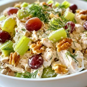For this Greek Yogurt Chicken Salad, you need a few simple ingredients. Each one adds flavor and texture. Here’s what you’ll need: - Chicken: Use 2 cups of cooked chicken breast. Shred it to bite-sized pieces. - Greek Yogurt: One cup of plain Greek yogurt gives a creamy base. - Vegetables and Fruits: You need ½ cup finely chopped celery and ½ cup red grapes, halved. They add crunch and sweetness. - Nuts and Herbs: Add ¼ cup chopped walnuts for crunch and 2 tablespoons fresh dill for fresh flavor. - Seasonings: Use 1 tablespoon Dijon mustard, 1 tablespoon honey, 1 tablespoon lemon juice, and salt and pepper to taste. These bring all the flavors together. These ingredients blend well for a tasty and healthy meal. Each item plays a role in making this salad both fresh and simple. {{ingredient_image_2}} First, grab a big mixing bowl. Add 2 cups of shredded chicken breast and 1 cup of plain Greek yogurt. Use a spatula or spoon to mix them well. Make sure all the chicken gets coated in the yogurt. This creates a creamy base for your salad. Next, it’s time to add some crunch and sweetness. Take ½ cup of finely chopped celery, ½ cup of halved red grapes, and ¼ cup of chopped walnuts. Gently fold these into the chicken and yogurt mix. Be careful with the grapes; you want to keep them whole for texture and flavor. In a small bowl, combine 2 tablespoons of fresh dill, 1 tablespoon of Dijon mustard, 1 tablespoon of honey, and 1 tablespoon of lemon juice. Add salt and pepper to taste. Whisk everything together until smooth. This dressing gives your salad a bright and zesty flavor. Now, pour the dressing over the chicken and veggie mixture. Carefully mix everything together. Make sure every bite gets some of that tasty dressing. This will help all the flavors blend beautifully. Cover your bowl with plastic wrap or a lid. Place it in the fridge for at least 30 minutes. This chilling time lets the flavors mingle and develop. It also makes the salad cool and refreshing. When you’re ready to serve, you have options. You can present the salad on a bed of crisp romaine lettuce for a light dish. Or, you can make a sandwich with whole grain bread. For an added touch, sprinkle extra chopped dill on top. You can also add whole walnuts for a nice crunch. Enjoy your fresh and simple meal! To get the best texture, use shredded chicken. I love to cook my chicken in advance. This makes it easy to shred right before mixing. Make sure your Greek yogurt is thick and creamy. A good brand will help your salad stay rich without being runny. When you fold in the celery and grapes, do it gently. You want to keep their crunch and shape. For a great taste, don’t skip the dill. It adds a fresh, bright flavor. The honey gives a touch of sweetness that balances the tangy yogurt. If you like spice, add a pinch of cayenne pepper. For a citrus boost, add more lemon juice. Taste as you mix. This way, you can adjust the flavors to your liking. To make your salad look great, use a colorful bowl. A bright plate makes the salad pop. Before serving, sprinkle extra dill on top. You can also add a few walnuts for a nice crunch. If you’re serving on lettuce, arrange it neatly. A well-presented dish makes it more inviting. Enjoy your beautiful Greek yogurt chicken salad! Pro Tips Use Fresh Ingredients: Fresh celery and grapes enhance the overall flavor and texture of the salad, making it more vibrant and enjoyable. Chill for Flavor: Allowing the salad to chill for at least 30 minutes lets the flavors meld together beautifully, resulting in a more delicious dish. Adjust to Taste: Feel free to customize the dressing with more honey or mustard based on your personal preference for sweetness or tanginess. Mix It Up: Experiment with different nuts or add-ins like apples or cranberries for a unique twist on this classic chicken salad. {{image_4}} You can change the protein in this salad. Instead of chicken, use shredded turkey. It has a nice flavor. You can also try diced tofu for a vegan choice. Both options add a new twist to your dish. You can even use canned tuna or salmon if you like seafood. Each protein brings its own taste and texture. Want to mix things up? Add different fruits like diced apples or pears. They add sweetness and crunch. You can also try using dried cranberries for a chewy bite. For a spicy kick, toss in some diced jalapeños. Fresh herbs like basil or parsley can brighten the taste. Each addition makes the salad unique and exciting. You can serve this salad in many ways. For a lighter meal, place it on a bed of greens. Romaine lettuce works great for this. If you want a hearty meal, use whole grain bread to make a sandwich. You can even scoop the salad into mini bell peppers for fun bites. These options keep every meal fresh and enjoyable. Store your Greek yogurt chicken salad in an airtight container. This keeps the salad fresh. Make sure to press out as much air as possible. This helps prevent spoilage. You can keep the salad in the fridge for up to three days. After that, the chicken may lose its freshness. Always check for any off smells or signs of spoilage. If in doubt, throw it out. You can use leftover chicken salad in many ways. Try it in a wrap with fresh veggies. You can also add it to a grain bowl. For a quick snack, eat it on whole grain crackers. If you want a twist, blend it into a dip for veggies. Yes, you can make Greek yogurt chicken salad ahead of time. I often prepare it the night before. This way, the flavors blend well and taste even better. Just store it in an airtight container in the fridge. Yes, Greek yogurt is generally healthier than mayonnaise. It has less fat and more protein. Greek yogurt also offers probiotics that help with digestion. This makes it a great choice for a lighter salad. If you need a substitute for walnuts, try almonds or pecans. Both add a nice crunch and flavor. You can even use sunflower seeds for a nut-free option. Just chop them up before adding to the salad. Yes, you can use canned chicken in this recipe. Make sure to drain it well before mixing. Canned chicken saves time and still tastes great. It’s a quick option for busy days. To make this dish lower in calories, use low-fat Greek yogurt. You can also reduce the amount of walnuts. Adding more vegetables like cucumbers or bell peppers helps keep it filling without adding too many calories. This blog post covered everything you need for a great Greek Yogurt Chicken Salad. We looked at key ingredients like chicken, yogurt, and fresh veggies. The step-by-step guide helped you mix and chill your salad. You learned tips to enhance texture and flavor too. We also explored variations and how to store leftovers. Making this salad is easy and fun. Enjoy experimenting with different ingredients and flavors. Your taste buds will thank you!