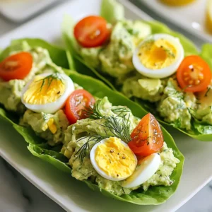 - 4 large eggs, hard-boiled and peeled - 1 ripe avocado - 2 tablespoons Greek yogurt - 1 tablespoon Dijon mustard - 1 tablespoon fresh lemon juice - 1 tablespoon fresh dill, finely chopped - Salt and freshly ground black pepper, to taste - 1 head of romaine lettuce, leaves carefully separated - Cherry tomatoes, halved (for garnish) If you need a swap, you can use mayonnaise instead of Greek yogurt. This will add creaminess. For a zesty touch, swap Dijon mustard with yellow mustard. If you don’t have fresh dill, dried dill works too, just use less. Each serving contains about 200 calories. This dish is high in protein and healthy fats. The eggs provide protein, while the avocado adds good fats and fiber. The Greek yogurt boosts the protein even more. Plus, the dish is low in carbs, making it a healthy choice for many diets. {{ingredient_image_2}} Start by hard-boiling four large eggs. Cool them down in ice water. Once cool, peel the eggs and chop them into small pieces. Place these pieces in a medium bowl. Next, take one ripe avocado. Cut it in half, remove the pit, and scoop the green flesh into the bowl with the eggs. Now, add two tablespoons of Greek yogurt into the bowl. This adds creaminess and flavor. Then, include one tablespoon of Dijon mustard for a tangy kick. Squeeze in one tablespoon of fresh lemon juice to brighten the dish. Add one tablespoon of fresh dill, chopped finely, for a burst of taste. Mix everything with a fork. Gently mash the avocado while blending it with the eggs. Keep some chunks for texture. Season with salt and black pepper to taste. Adjust the seasoning based on your preference. Take one head of romaine lettuce and carefully separate the leaves. Choose sturdy leaves for the wraps. Place a generous spoonful of the avocado egg salad in the center of a leaf. Fold the sides of the leaf over the filling, creating a wrap. If needed, use a toothpick to hold it together. Repeat this with the rest of the leaves and salad. Serve immediately, garnished with halved cherry tomatoes for a colorful touch. Enjoy your fresh and tasty avocado egg salad lettuce wraps! When picking an avocado, look for one that feels slightly soft. Gently press the skin with your thumb. If it gives a little, it’s ripe. Avoid avocados that feel too mushy or have dark spots. These signs mean the fruit may be overripe. You can buy hard avocados if you plan to use them later. Just let them sit on the counter for a few days. To keep your egg salad fresh, store it in an airtight container. This helps prevent it from drying out. Use it within two days for the best taste. If you want to prep ahead, store the salad mix and lettuce separately. This keeps the lettuce crisp. You can also add a splash of lemon juice to slow browning. Herbs and spices can boost your avocado egg salad. Fresh dill gives a nice touch, but you can try others too. Chives, parsley, or cilantro work well. For a bit of heat, add a pinch of cayenne pepper. You can also mix in some garlic powder for a savory kick. Just remember to taste as you go. Adjust the seasoning to suit your style. Pro Tips Use Fresh Eggs: For the best flavor and texture, use the freshest eggs possible. Fresh eggs tend to have a more vibrant yolk and better overall taste. Ripeness Matters: Ensure your avocado is perfectly ripe for a creamy and smooth texture. If it’s too firm, it won’t blend well with the eggs. Customize Your Herbs: Feel free to experiment with different herbs like chives or parsley instead of dill for a unique flavor profile. Make Ahead: You can prepare the egg salad filling in advance and store it in the refrigerator. Just assemble the wraps right before serving to keep the lettuce crisp. {{image_4}} You can boost your avocado egg salad by adding chicken or tuna. Both options make it heartier. Simply shred or chop cooked chicken and mix it in. For tuna, use canned tuna, drained well. This adds protein and flavor. You might want to adjust the seasoning. Taste as you mix to get it just right. If you want a vegan twist, try using chickpeas instead of eggs. Mash canned chickpeas with a fork. Add avocado and Greek yogurt alternatives like silken tofu or vegan mayo. This keeps the creamy texture. Season with lemon juice and dill for flavor. You can still enjoy the same great taste without eggs. Experiment with spices to change the flavor. For a spicy kick, add chopped jalapeños or a dash of hot sauce. If you like sweet, mix in diced apples or a bit of honey. For a smoky taste, try smoked paprika or chipotle powder. These small changes can create a new dish each time you make it. To keep your avocado egg salad fresh, store it in an airtight container. This prevents the salad from absorbing odors in your fridge. It's best to avoid letting it sit out at room temperature for long. If you have extra lettuce leaves, keep them separate. This keeps the lettuce crisp and fresh. When stored properly, avocado egg salad lasts up to three days in the fridge. After this time, the avocado may turn brown and the eggs can become less tasty. Always check for any off smells or changes in texture before eating leftovers. Freezing avocado egg salad is not recommended. The texture of the eggs and avocado changes when frozen. Instead, prepare smaller batches if you want to enjoy this dish later. You can make the salad fresh as needed to keep it at its best taste and texture. Yes, you can use other types of lettuce for wraps. Butter lettuce, green leaf, or even cabbage work well. Each type adds its own flavor and texture. Choose a sturdy leaf that holds the filling well. If you prefer a crunchier wrap, cabbage is a great choice. For a softer bite, butter lettuce is perfect. Yes, this recipe is great for meal prep! You can make the avocado egg salad ahead of time. Store it in an airtight container in the fridge. It will stay fresh for about three days. However, I suggest waiting to assemble the wraps until you're ready to eat. This keeps the lettuce crisp and prevents sogginess. These wraps pair well with many sides. Fresh fruit, like sliced apples or berries, adds a sweet touch. You can also serve them with crunchy veggie sticks, like carrots or cucumbers. For a heartier meal, consider a side of quinoa or a light soup. These options balance the flavors and make a complete meal. This blog post covered everything you need to make delicious avocado egg salad wraps. We discussed key ingredients, substitutions, and the nutritional value. You learned step-by-step instructions for preparing and mixing the ingredients, along with tips for freshness. We explored fun variations and storage options to keep your salad tasty longer. Remember, cooking should be enjoyable. Use these insights to create your own unique wraps. Happy cooking!