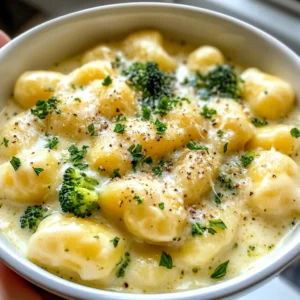 To make creamy broccoli cheddar gnocchi, you will need simple ingredients. Here’s what you’ll gather: - 1 pound gnocchi (store-bought or homemade) - 2 cups broccoli florets - 1 cup sharp cheddar cheese, freshly shredded - 1 cup heavy cream - 1 tablespoon olive oil - 2 cloves garlic, finely minced - ½ teaspoon onion powder - Salt and freshly cracked black pepper to taste - ¼ cup grated Parmesan cheese (for garnish) - Fresh parsley, finely chopped (for garnish) Gathering these ingredients is easy and quick. Use fresh broccoli for a bright taste and color. The sharp cheddar cheese adds a rich flavor. Heavy cream makes the dish smooth and creamy. You can find gnocchi in most stores, but making it at home is fun too! Once you have everything, you’re ready to cook. This dish feels special yet is simple enough for any cook. The combination of flavors brings comfort and joy to the table. Enjoy the process of cooking! {{ingredient_image_2}} Start by boiling a large pot of salted water. Bring the water to a rolling boil. Once boiling, carefully add 1 pound of gnocchi. Cook them based on the package instructions. They are ready when they float to the top, which usually takes about 2-3 minutes. Use a slotted spoon to remove the gnocchi from the water. Set them aside on a plate. In the same pot, add 1 tablespoon of olive oil over medium heat. Let the oil warm for a moment. Next, add 2 minced garlic cloves. Sauté the garlic for about 1 minute. You want it to be fragrant and lightly golden, not burnt. Now, toss in 2 cups of broccoli florets. Sauté them for about 3-4 minutes. Cook until the broccoli is bright green and just tender but still crisp. Reduce the heat to low and pour in 1 cup of heavy cream. Stir gently to mix everything. Let the mixture come to a gentle simmer. Gradually stir in 1 cup of shredded sharp cheddar cheese and ½ teaspoon of onion powder. Mix until the cheese fully melts and the sauce becomes creamy. Taste and add salt and black pepper as needed. Gently add the cooked gnocchi back into the pot. Carefully toss them so they are coated in the rich sauce. Cook everything together for another 2-3 minutes. This step ensures all the flavors blend well. Serve the creamy broccoli cheddar gnocchi on plates, topping each dish with ¼ cup of grated Parmesan cheese and a sprinkle of fresh parsley for color and taste. When it comes to gnocchi, you have two main choices: store-bought or homemade. Store-bought gnocchi is quick and easy. You can find many types in grocery stores. They cook up nicely and save time. If you want to try making homemade gnocchi, it can be a fun project. It involves mixing potatoes, flour, and egg. Homemade gnocchi often tastes fresher and has a unique texture. Choose what works best for you! To achieve the right sauce consistency, keep a few tips in mind. Start with heavy cream for richness. Heat it gently to avoid boiling. Stir in the cheddar cheese slowly. This helps it melt smoothly. If the sauce gets too thick, add a splash of milk or water. The sauce should be creamy but not overly runny. Taste and season with salt and pepper to enhance the flavor. You can easily add more flavor to your dish. Consider using fresh herbs like thyme or basil. A pinch of red pepper flakes can add heat. If you like a smoky taste, try adding smoked paprika. You can also mix in a bit of lemon juice for brightness. Experiment with these extras to find your favorite combination! Pro Tips Use Fresh Broccoli: Fresh broccoli gives the best flavor and texture. If using frozen, make sure to thaw and drain excess water before adding to the dish. Shred Your Own Cheese: Pre-shredded cheese often contains anti-caking agents that can affect melting. Grate your cheese fresh for a smoother, creamier sauce. Adjust the Creaminess: For a lighter version, substitute half of the heavy cream with vegetable broth or milk. This will maintain flavor while reducing richness. Garnish for Freshness: Fresh parsley not only adds a pop of color but also enhances the dish's flavor. Consider adding a squeeze of lemon for brightness. {{image_4}} You can add more veggies to your creamy broccoli cheddar gnocchi for extra taste. Here are some ideas: - Cauliflower: It cooks fast and adds nice texture. - Spinach: Fresh or frozen, it brings a pop of color and nutrients. - Peas: Sweet and bright, they mix well with the creamy sauce. - Carrots: Thinly sliced, they add a crunch and sweetness. - Bell Peppers: Choose any color for a sweet and crunchy bite. Feel free to mix and match these options to suit your taste. If you want to try different cheeses, there are many options. Here are a few that work well: - Monterey Jack: It melts beautifully and adds a mild flavor. - Gruyère: This cheese has a nutty taste and adds depth to the dish. - Cream Cheese: For a super creamy texture, try this. - Feta: Crumbled feta can give a tangy twist to the dish. Experiment with these cheeses to find your favorite combination. To make this dish vegan, swap out a few ingredients: - Use vegan gnocchi. Many brands offer dairy-free options. - Replace heavy cream with coconut cream or cashew cream. - Choose a vegan cheese that melts well, like a cashew or almond-based cheese. These simple swaps keep the flavors while making it plant-based. Enjoy a creamy, dairy-free version of this tasty dish! To keep your creamy broccoli cheddar gnocchi fresh, place it in an airtight container. This helps prevent moisture loss and keeps flavors intact. Store it in the fridge for up to three days. If you want to save it longer, consider freezing. When it's time to enjoy the leftovers, reheat gently. You can use a pot on the stove over low heat. Add a splash of cream or milk to keep it creamy. Stir often to avoid sticking. You can also use a microwave. Heat in short bursts, stirring in between, until it's hot throughout. Yes, you can freeze creamy broccoli cheddar gnocchi! Allow it to cool completely before freezing. Use a freezer-safe container or bag. It can stay frozen for up to three months. When ready to eat, thaw it in the fridge overnight. Then, reheat as mentioned above for the best results. Yes, you can use frozen broccoli. It’s quick and easy. Frozen broccoli cooks faster than fresh. It also saves prep time. Just add it to your pot with the garlic. Cook until it’s bright green and tender. The flavor stays great, and you won’t lose any nutrients. This dish takes about 20 minutes total. You will need 10 minutes to prep. Cooking the gnocchi and making the sauce takes another 10 minutes. It’s a fast recipe, perfect for busy nights. You can enjoy a warm meal in no time. Yes, you can prep this dish ahead of time. Cook the gnocchi and sauce separately. Store them in the fridge for up to three days. When you’re ready, heat them together on the stove. This keeps the flavors fresh and tasty. You can also freeze it, but the texture may change. Enjoy this easy meal whenever you want! This recipe for Creamy Broccoli Cheddar Gnocchi is simple and tasty. We covered the key ingredients like gnocchi, broccoli, and cheese. The step-by-step guide ensured you cook it perfectly. I shared tips on choosing ingredients and enhancing flavors, plus variations to suit your taste. Finally, I provided storage tips for leftovers. Enjoy this dish any time, knowing it's easy and delicious. Keep experimenting with the recipe for new flavors!