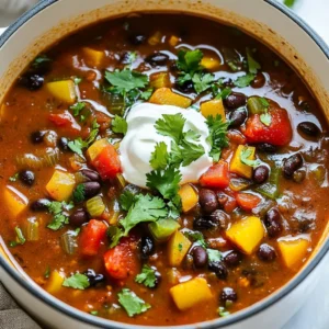 For this cozy dish, gather the following items: - 2 cups dried black beans (or 4 cans, drained and rinsed) - 1 medium onion, finely diced - 3 cloves garlic, minced - 1 medium bell pepper (any color), diced - 1 medium carrot, diced - 1 celery stalk, diced - 1 can (14 oz) diced tomatoes (with juice) - 4 cups vegetable broth - 2 teaspoons ground cumin - 2 teaspoons chili powder - ½ teaspoon smoked paprika - ½ teaspoon cayenne pepper (adjust to your spice preference) - Salt and freshly ground black pepper to taste - 1 tablespoon olive oil - Juice of 1 fresh lime - Fresh cilantro, roughly chopped, for garnish - Optional toppings: sour cream or diced avocado You can switch some ingredients to fit your taste or what's in your pantry: - Use canned beans for quick prep. - Swap bell pepper for jalapeño for extra heat. - Replace vegetable broth with chicken broth if you like. - Use fresh herbs like parsley if cilantro isn’t your favorite. - For a creamier soup, add coconut milk instead of lime juice. This soup is hearty and healthy. Here’s what you get per serving: - Calories: 210 - Protein: 12g - Carbohydrates: 35g - Dietary Fiber: 10g - Fat: 6g - Sodium: 400mg - Vitamin A: 30% of daily value - Vitamin C: 25% of daily value This information helps you gauge how the soup fits into your diet. Enjoy the warmth and flavor while nourishing your body! {{ingredient_image_2}} Start by deciding if you want to use dried or canned beans. If you choose dried beans, soak them overnight in water. This helps them cook faster. The next day, drain and rinse the beans before using. If you prefer canned beans, just drain and rinse them under cold water. Canned beans save time and still taste great. Next, grab a large pot and heat some olive oil over medium heat. Add the diced onion, bell pepper, carrot, and celery. Stir them every now and then for about 5 to 7 minutes. This step makes the veggies soft and lets their flavors bloom. You want them to smell delicious! Now it's time to spice things up! Add the minced garlic along with ground cumin, chili powder, smoked paprika, cayenne pepper, salt, and black pepper. Stir for another 1 to 2 minutes. This will make the spices fragrant. Then, add the soaked (or canned) black beans and diced tomatoes with their juice. Pour in the vegetable broth and stir everything well. Bring this mix to a boil, then reduce the heat. Cover the pot and let it simmer. If you're using dried beans, simmer for 30 to 40 minutes. If you went with canned beans, 15 to 20 minutes will do. This step lets the beans soften and all the flavors come together. After simmering, you can choose how smooth you want your soup. Use an immersion blender to puree part of it for creaminess. If you like it chunky, leave it as is. Both ways taste great and add a unique feel to the soup! Before serving, stir in fresh lime juice. Taste the soup and add more salt and pepper if needed. Serve it hot in bowls and sprinkle with fresh cilantro. For an extra treat, add sour cream or avocado on top. This soup is cozy, filling, and sure to warm you up! To make your soup just right, you can change the spice. Start with a little cayenne pepper. If you like more heat, add more a bit at a time. Taste after each addition. You can also add a splash of hot sauce for extra kick. If it gets too hot, add more beans or a dollop of sour cream to cool it down. Flavor is key in any dish. Here are some tips to boost your soup's taste: - Use fresh spices for a bold flavor. - Sauté your vegetables until they soften. This step helps release their natural sugars. - Adding lime juice at the end brightens all the flavors. - Let the soup sit for a few hours or overnight. This allows the flavors to deepen. Serve your spicy black bean soup hot. Here are some great ideas for sides and toppings: - Top with fresh cilantro for a vibrant touch. - Add a dollop of sour cream or creamy avocado for richness. - Pair with warm crusty bread or tortilla chips for a crunchy bite. - Serve with a side salad for a fresh, light meal. These tips will help you make the best spicy black bean soup. Enjoy! Pro Tips Soaking Beans: Soaking dried black beans overnight not only reduces cooking time but also helps improve their digestibility and flavor. Spice Adjustment: Feel free to adjust the cayenne pepper based on your spice tolerance. Start with less and add more if you desire a spicier kick! Texture Preference: If you enjoy a chunkier soup, only blend a portion of it. This adds creaminess while still keeping some beans whole for that hearty texture. Flavor Enhancer: Adding lime juice just before serving brightens the flavors of the soup, giving it a fresh and zesty finish. {{image_4}} You can easily make this soup vegan or vegetarian. Start with vegetable broth, which is already in the recipe. Use canned beans or soaked dried beans, both are great choices. This soup is packed with flavor, so you won't miss any meat. Add a splash of coconut milk for a rich twist. You can also try adding more spices, like coriander or turmeric, for extra depth. For a heartier soup, consider adding protein or grains. You can mix in cooked quinoa or brown rice for added texture. If you want to add protein, try chickpeas or diced tofu. These options help make the soup more filling and nutritious. You can also use shredded chicken if you prefer a non-vegetarian option. Feel free to swap or add different vegetables. Corn adds a sweet crunch, while zucchini offers a nice texture. Spinach or kale can boost the nutrition and color. If you like a bit of heat, diced jalapeños work great. Carrots and celery are already in the recipe, but you can add bell peppers of different colors for a colorful soup. Mixing in seasonal veggies keeps it fresh and fun! After you enjoy your spicy black bean soup, let it cool first. Pour it into an airtight container. This keeps it fresh. Store the container in the fridge. It will last for about 3 to 5 days. You can also save it in smaller portions for easy meals. When you are ready to eat the leftovers, take the soup out of the fridge. Pour it into a pot over medium heat. Stir it often to warm it up evenly. If it looks thick, add a little water or broth. Heat until hot, but don’t let it boil. To freeze the soup, use freezer-safe containers. Make sure to leave some space at the top. The soup will expand as it freezes. It can stay in the freezer for up to 3 months. When you want to eat it, move it to the fridge to thaw overnight. Then, reheat it as mentioned above. Enjoy your soup anytime with these easy storage tips! Yes, you can use canned beans. They save time and are easy to use. Just drain and rinse them before adding to the soup. If you use canned beans, reduce the cooking time. Simmer for about 15 to 20 minutes instead of 30 to 40 minutes. This helps the flavors blend well without overcooking the beans. To make the soup milder, cut back on the cayenne pepper. You can start with a pinch or skip it altogether. Another option is to add more vegetables like carrots or bell peppers. This will balance the spice. You can also serve sour cream or avocado on top to cool down the heat. Common toppings for Spicy Black Bean Soup include: - Sour cream - Diced avocado - Fresh cilantro - Chopped green onions - Crumbled tortilla chips These toppings add flavor and texture, making each bowl even better. Yes, you can make this soup in a slow cooker! Just follow these steps: 1. Prepare the beans as you would for stovetop cooking. 2. Sauté the vegetables in a pan first for better flavor. 3. Add all ingredients to the slow cooker. 4. Cook on low for 6 to 8 hours or on high for 3 to 4 hours. This method allows the flavors to meld beautifully, giving you a rich and hearty soup. This blog covered how to make a delicious Spicy Black Bean Soup. We reviewed all the ingredients, including smart substitutions and nutritional facts. I shared simple steps for cooking, sautéing, and simmering to achieve the best texture. You learned tips for adjusting spice levels and pairing suggestions to enhance flavor. We also explored variations, including vegan options and protein additions. Finally, you now know the best ways to store and reheat leftovers. Enjoy making this soup your own and savor each bowl!