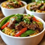 - 200g beef sirloin, thinly sliced - 200g flat rice noodles - 1 red bell pepper, sliced into thin strips - 1 cup snow peas, trimmed - 3 cloves garlic, minced - 1-inch piece ginger, minced - 2 green onions, chopped (white and green parts separated) - 2 tablespoons soy sauce - 1 tablespoon dark soy sauce - 1 tablespoon oyster sauce - 1 tablespoon honey - 1 teaspoon sesame oil - Sesame seeds for garnish - Fresh cilantro leaves for garnish The main ingredients form the backbone of sticky beef noodles. The beef sirloin gives the dish its rich flavor and tenderness. Flat rice noodles soak up all the tasty sauces, making each bite a delight. Fresh vegetables, like bell pepper and snow peas, add a crunchy texture and bright color. The sauces and seasonings elevate the dish's taste. Soy sauce provides saltiness, while oyster sauce adds depth. Honey brings a hint of sweetness that balances the flavors. Sesame oil adds a nutty aroma, making each bite even more enjoyable. Finally, garnishing with sesame seeds and cilantro gives a fresh finish. These ingredients work together to create a meal that is not just tasty but colorful and appealing. You’ll love how they blend to make sticky beef noodles a hit at your table! {{ingredient_image_2}} To cook the rice noodles, start by boiling water in a large pot. Add the flat rice noodles and cook them according to the package instructions. You want them to be al dente, which means they should still have a slight bite. Once they are cooked, drain the noodles in a colander and set them aside for later. Marinating the beef is key for great flavor. This step helps the beef absorb all the tasty sauces. In a mixing bowl, combine the thinly sliced beef with soy sauce, dark soy sauce, oyster sauce, honey, and sesame oil. Make sure every piece is well coated. Let the beef marinate for about 15 minutes. This will deepen the flavors and make your dish more delicious. For cooking the beef, heat one tablespoon of vegetable oil in a large skillet or wok over medium-high heat. Once the oil is hot and shimmering, add the marinated beef. Spread it out in a single layer, so it cooks evenly. Stir-fry for 2-3 minutes until the beef is browned and cooked through. Once done, remove the beef from the skillet and place it on a plate. Next, it’s time to sauté the vegetables. In the same skillet, add another tablespoon of vegetable oil. When the oil is hot, toss in the minced garlic and ginger. Stir them quickly for about 30 seconds until you can smell the aroma. Then, add the sliced red bell pepper and snow peas. Stir-fry for an additional 3-4 minutes. The veggies should be tender but still crisp. Now it’s time to combine everything. Return the cooked beef to the skillet with the sautéed vegetables. Then add the drained rice noodles. Use tongs or a spatula to gently toss everything together. Make sure the beef and veggies are evenly mixed with the noodles. For the final seasoning, take a moment to taste your dish. You may want to adjust the flavors by adding a splash more soy sauce or a drizzle of honey to enhance the sweetness. This step is crucial for achieving that rich flavor you want in every bite. To make your beef tender, choose sirloin. Slice it thinly against the grain. This helps the meat stay soft. Marinating the beef is key. Use soy sauce, dark soy sauce, oyster sauce, honey, and sesame oil. Let it soak for at least 15 minutes. This adds deep flavor to the beef. For flavor, try adding more garlic or ginger. You can also play with the sauces. A bit more honey can add sweetness. If you want a kick, add a pinch of chili flakes. Taste as you go and adjust as needed. Plating is important for a great meal. Serve sticky beef noodles in deep bowls. This shows off the bright colors of the veggies. For a finishing touch, drizzle honey or sesame oil on top. This adds shine and flavor. Garnish with chopped green onions and sesame seeds. Fresh cilantro adds a nice pop of color. These simple touches make your dish look restaurant-worthy. A beautiful plate makes every bite more enjoyable! Pro Tips Choose the Right Noodles: Opt for good quality flat rice noodles as they absorb the flavors better and enhance the overall texture of the dish. Marinating Time: Allow the beef to marinate for at least 15 minutes to deepen the flavor; for best results, you can marinate it for up to an hour in the fridge. High Heat Cooking: Stir-frying over medium-high heat ensures that the beef gets a nice sear while keeping the vegetables crisp and vibrant. Garnish to Impress: Don’t skip the garnish! Fresh cilantro and sesame seeds not only enhance the presentation but also add a fresh and nutty flavor. {{image_4}} If you want a change from beef, you can use chicken or tofu. Both options work well in sticky beef noodles. Chicken adds a mild flavor, while tofu gives a nice texture. For a vegetarian meal, tofu is a great choice. It absorbs the sauce well and soaks up all the flavors. Feel free to play with seasonal vegetables. You can try broccoli, carrots, or bok choy for added crunch. Each vegetable brings new textures and colors to the dish. Mixing in seasonal produce can make your meal fresh and exciting. You can experiment with different sauces to change the taste. Try adding hoisin sauce for a sweet kick or chili sauce for heat. Adjust the sweetness by adding more honey or use soy sauce for saltiness. These small tweaks can make a big difference in flavor! To keep your sticky beef noodles fresh, store them in an airtight container. This helps prevent drying out. Place them in the fridge right away. They can last for 2 to 3 days. If you want to keep them longer, consider freezing them. In the freezer, they can last for about a month. When you are ready to eat them, just thaw overnight in the fridge. When reheating sticky beef noodles, avoid the microwave if you can. Instead, use a skillet or wok. This method helps keep the noodles' texture. Heat a small amount of oil in the pan. Add the noodles and stir them gently. This will help them warm evenly. You can also add a splash of soy sauce. This adds moisture and flavor back to the dish. If the noodles seem dry, a little water works too. Enjoy your delicious meal just like when it was fresh! If you can't find flat rice noodles, you have options. You can use: - Spaghetti or linguine - Udon noodles - Soba noodles These noodles will give you a similar texture. Just be sure to adjust the cooking time. Yes, you can make sticky beef noodles ahead of time. Here are some tips: - Cook the noodles and beef, then cool them quickly. - Store them in airtight containers in the fridge. - Reheat gently in a pan or microwave before serving. This way, you save time on busy days. Sticky beef noodles pair well with several side dishes. Consider: - Steamed broccoli or bok choy - A simple cucumber salad - Egg rolls or spring rolls These sides add balance and enhance your meal. To scale the recipe up, follow these steps: - Double or triple the ingredients based on servings needed. - Keep the same cooking times, but check for doneness. - Use a larger skillet or wok for even cooking. This way, everyone enjoys a tasty meal! This article covered everything you need to make sticky beef noodles at home. We explored main ingredients like beef sirloin, flat rice noodles, and various sauces. I shared step-by-step instructions, cooking tips, and ways to make this dish shine on your plate. In the end, cooking is about making it your own. Use my tips to try new flavors or ingredients. Enjoy your meal and share it with friends! Your kitchen adventures await!