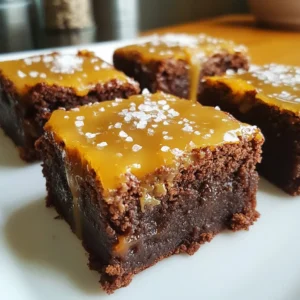 To make these salted caramel brownie bites, you need the following ingredients: - 1 cup unsweetened cocoa powder - 1 cup granulated sugar - ½ cup packed brown sugar - ½ cup unsalted butter, melted - ¼ cup vegetable oil - 4 large eggs - 1 teaspoon vanilla extract - 1 cup all-purpose flour - 1 cup semi-sweet chocolate chips - ½ cup store-bought salted caramel sauce - Sea salt, for finishing These ingredients work together to create a rich, gooey, and sweet treat. The key ingredients that really boost the flavor are: - Cocoa Powder: This gives the brownies a deep chocolate taste. - Brown Sugar: It adds moisture and a slight caramel flavor. - Salted Caramel Sauce: This introduces a sweet and salty contrast. - Sea Salt: Just a pinch at the end makes the flavors pop. These elements elevate the taste and make each bite a satisfying experience. If you have allergies or dietary preferences, here are some easy swaps: - Butter: Use coconut oil or margarine for a dairy-free option. - Eggs: Substitute with mashed bananas or unsweetened applesauce (¼ cup per egg). - All-Purpose Flour: Try almond flour or a gluten-free blend. - Chocolate Chips: Select dairy-free chocolate chips for a vegan treat. These substitutions help you enjoy the brownie bites without worry. {{ingredient_image_2}} Start by preheating your oven to 350°F (175°C). While it heats, get your mini muffin pan ready. You can grease it lightly with cooking spray or use mini paper liners. Liners make it easy to remove the brownie bites later. In a large bowl, combine melted unsalted butter and vegetable oil. Next, add granulated sugar and brown sugar. Whisk these ingredients until smooth. This mix creates a rich base for your brownies. Now, crack in four large eggs, one at a time. Whisk after each egg to blend well. Then, stir in one teaspoon of vanilla extract to add flavor. Sift in one cup of unsweetened cocoa powder and one cup of all-purpose flour. Use a spatula to fold these dry ingredients into the wet mix. Be gentle! A few lumps are fine and add texture to the bites. Finally, fold in one cup of semi-sweet chocolate chips. This will give your brownie bites delightful bursts of chocolate. Use a tablespoon to fill each muffin cup halfway with the brownie batter. Aim for equal amounts in each cup. Then, place about one teaspoon of salted caramel sauce on top of the batter in each cup. This creates a gooey layer. Top with more brownie batter until the cups are about three-quarters full. This allows room for them to rise while baking. Now, bake in your preheated oven for 15-18 minutes. Check for doneness by inserting a toothpick into the center. If it comes out with a few moist crumbs, they’re ready. After baking, let the bites cool in the pan for a few minutes. Then, transfer them to a wire rack to cool fully. Just before serving, sprinkle a pinch of sea salt on top. This enhances the caramel and chocolate flavors, making each bite a true treat. To get the best texture in your brownie bites, follow these simple steps: - Use room temperature eggs. This helps them blend well. - Don’t over-mix the batter. A few lumps are okay and add to the texture. - Bake them just right. Check for doneness with a toothpick; it should have a few moist crumbs. These steps keep your brownie bites soft and fudgy inside, with a slight crust on the outside. Trust me, it makes a big difference! Caramel sauce adds a lovely flavor and gooeyness. Here’s how to use it well: - Choose a good quality store-bought salted caramel sauce. It saves time and tastes great. - Use a teaspoon to drop the caramel on top of the brownie batter. This will give you a nice layer. - Don’t overdo the caramel. A little goes a long way in flavor and keeps the bites from being too sweet. These tips let the caramel shine without overpowering the brownie flavor. Keeping your brownie bites fresh is easy: - Store them in an airtight container at room temperature for up to 3 days. - For longer storage, place them in the fridge. They stay good for about a week. - To reheat, use the microwave for 10-15 seconds. This warms them up and makes them soft again. These methods keep your brownie bites tasty and ready to enjoy at any time! Pro Tips Use Quality Chocolate: Opt for high-quality semi-sweet chocolate chips as they will enhance the overall flavor of your brownie bites. Room Temperature Ingredients: Ensure your eggs and butter are at room temperature to help create a smooth batter and ensure even baking. Don’t Overbake: Keep a close eye on your brownie bites in the oven; they should be fudgy in the center for the best texture. Chill for Extra Gooeyness: For an even more indulgent treat, chill the brownie bites in the fridge for a bit after they cool to enhance the caramel’s consistency. {{image_4}} You can enhance your brownie bites by adding nuts or other mix-ins. Chopped walnuts or pecans give a nice crunch. Just fold in about ½ cup of nuts after mixing in the chocolate chips. You could also try adding mini marshmallows or even dried fruit for extra flavor. This will add texture and make each bite more exciting. For a gluten-free version, replace all-purpose flour with a gluten-free blend. Make sure the blend includes xanthan gum for the right texture. For a vegan option, substitute eggs with flax eggs. Mix 1 tablespoon of ground flaxseed with 2.5 tablespoons of water for each egg. Use a dairy-free butter or oil to keep it vegan. These swaps keep the flavor and texture delicious. If you want to switch up the flavor, think beyond salted caramel. You can use different sauces, like chocolate or raspberry. Just drizzle some on top before baking. You could also add a dash of peppermint extract for a holiday twist. Or try adding espresso powder to the batter for a coffee flavor. Each option opens up new taste experiences. Store your salted caramel brownie bites in an airtight container. This keeps them fresh and moist. You can place a piece of parchment paper between layers if you stack them. Make sure to store them at room temperature for up to three days. If you want to keep them longer, the fridge works too. Just remember, the cold can change the texture a bit. To freeze brownie bites, let them cool completely first. Then, wrap each bite in plastic wrap. Place them in a freezer bag or airtight container. They can last for up to three months in the freezer. When you want to enjoy them, take out as many as you need. Thaw them in the fridge overnight or at room temperature for a few hours. You can also warm them in the microwave for a few seconds. After storage, I suggest serving the brownie bites warm. If you reheated them, drizzle some extra salted caramel sauce on top. A sprinkle of sea salt will make the flavors pop. These bites pair well with a scoop of vanilla ice cream or a dollop of whipped cream. This adds a delicious contrast to the rich chocolate. Yes, you can make these brownie bites ahead of time. You can bake them and store them in an airtight container. Keep them at room temperature for up to three days. If you want to keep them longer, place them in the fridge. Just remember to let them come to room temperature before serving. To check if your brownie bites are done, use a toothpick. Insert it into the center of one brownie bite. If it comes out with a few moist crumbs, they are ready. If it comes out wet with batter, they need more time. Aim for 15-18 minutes of baking time for perfect brownie bites. These brownie bites pair well with many treats. Try serving them with vanilla ice cream for a classic combo. A drizzle of extra salted caramel sauce adds a sweet touch. Fresh berries can also bring a nice tartness. Enjoy them with a cup of coffee or tea for a cozy dessert moment. In this post, we explored the key ingredients for delicious brownie bites and shared easy steps to make them. We discussed tips for the best texture and tasty variations to suit your needs, like gluten-free and vegan options. Finally, we covered how to store these treats for freshness. Remember, with simple tweaks, you can create your perfect brownie bites. Enjoy baking and share these delights with others!