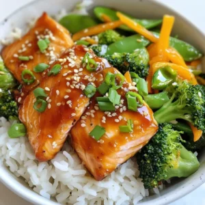 - 2 salmon fillets (approximately 6 oz each) - ¼ cup teriyaki sauce - 1 cup jasmine rice - 1 cup broccoli florets - 1 carrot, cut into thin matchsticks (julienne) - ½ cup sugar snap peas, trimmed - 1 tablespoon sesame oil - 2 green onions, sliced diagonally - 1 tablespoon sesame seeds, toasted Gather all these items before you start cooking. The salmon gives a rich taste. The teriyaki sauce adds sweetness and depth. Jasmine rice brings a nice touch of fragrance. Fresh vegetables add crunch and color. Each part works together to make a tasty dish. {{ingredient_image_2}} To start, rinse the rice well. Use a fine-mesh sieve and cold water. Rinse until the water runs clear. This helps remove extra starch. It prevents the rice from being too sticky. Now, cook the rice. In a medium saucepan, combine 1 cup of rinsed rice with 2 cups of water. Bring it to a vigorous boil over medium-high heat. Once boiling, reduce the heat to low. Cover the pot tightly and simmer for about 15 minutes. The rice should absorb all the water and be tender. After cooking, remove from heat and let it rest for 5 minutes with the lid on. This steaming step makes the rice light and fluffy. While the rice cooks, marinate the salmon. Place 2 salmon fillets in a shallow dish. Pour ¼ cup of teriyaki sauce over the fillets. Let them soak for about 15 minutes. Turn the fillets halfway through. This ensures they soak up all the tasty flavors. Next, stir-fry the vegetables. Heat 1 tablespoon of sesame oil in a large skillet over medium-high heat. Add 1 cup of broccoli florets, 1 julienned carrot, and ½ cup of sugar snap peas to the skillet. Stir-fry these for about 5 minutes. Stir frequently. Cook until they are tender but still crisp. Season with salt and black pepper to taste. Once done, remove the veggies from the heat and set them aside. Now, cook the salmon. Use the same skillet without wiping it out. Push the cooked veggies to one side of the pan. Place the marinated salmon fillets in the empty space. Cook them for 4-5 minutes on each side. The salmon should be cooked through and have a nice glaze from the teriyaki sauce. It's time to assemble the rice bowls. Scoop a generous portion of the jasmine rice into each bowl. Place a salmon fillet on top of the rice. Add a hearty serving of the stir-fried vegetables alongside the salmon. This creates a balanced and colorful meal. To finish, garnish the dish. Top each bowl with sliced green onions and a sprinkle of toasted sesame seeds. These add a lovely crunch and flavor. For an appealing presentation, serve with a small dish of extra teriyaki sauce on the side. You can also add a wedge of lime. A squeeze of lime juice adds a fresh touch just before enjoying your meal. How to check for doneness To ensure your salmon is cooked right, look for a few signs. The fish should change from bright pink to a light, opaque pink. You can also use a fork to flake the flesh. If it flakes easily, it’s done! Preventing dryness To keep your salmon moist, don’t overcook it. Cook for about 4-5 minutes on each side. Marinating in teriyaki sauce helps lock in moisture, too. If you’re still worried, a drizzle of olive oil before cooking can add extra juiciness. Suggestions for extra toppings You can elevate your rice bowl with many toppings. Try adding sliced avocado, pickled ginger, or even a soft-boiled egg. A sprinkle of chopped cilantro or sesame seeds adds flavor and crunch. Flavor variations Want to mix things up? Swap teriyaki sauce for sweet chili sauce or miso glaze. You can also add some spice with chili flakes or sriracha for a kick. Time-saving tips for busy cooks If you’re short on time, consider using a rice cooker for the jasmine rice. It frees you up for other tasks. Pre-cut or frozen vegetables can save you prep time. You can also marinate the salmon the night before to infuse flavor before cooking. Pro Tips Marinate for Flavor: Allow the salmon to marinate for at least 30 minutes if time permits. This enhances the flavor absorption, making the fish even more delicious. Perfect Rice Texture: For the fluffiest jasmine rice, remember to let it rest covered after cooking. This steaming step allows the grains to separate beautifully. Fresh Vegetables: Use fresh, seasonal vegetables for the best flavor and texture. Crisp-tender veggies add a delightful crunch to your bowl. Garnish for Appeal: Don’t skip the garnishes! A sprinkle of toasted sesame seeds and green onions not only adds flavor but also elevates the visual appeal of your dish. {{image_4}} You can switch salmon for chicken or tofu easily. If you choose chicken, use boneless, skinless thighs. Marinate them in teriyaki sauce the same way. For tofu, press it first to remove extra moisture. Cut the tofu into cubes and marinate for about 30 minutes. Cook it in the skillet until golden brown. Both options add their unique flavors to the rice bowl. While teriyaki sauce is fantastic, you can try other sauces too. Soy sauce mixed with honey gives a sweet touch. You can also use hoisin sauce for a richer flavor. A sweet chili sauce adds a nice kick. Experiment with your favorite sauces to find what you love most. Using seasonal vegetables keeps your meal fresh and exciting. In spring, add asparagus or snap peas. Summer is perfect for zucchini and bell peppers. In fall, try adding roasted butternut squash or Brussels sprouts. Winter vegetables like kale or cabbage work well too. This way, you can enjoy different tastes all year round! To store leftovers, let the rice bowls cool first. Place each bowl in a tight container. Keep them in the fridge for up to three days. Make sure to cover the salmon well. This keeps it fresh and tasty. Freezing is a great option if you want to save some for later. Use freezer-safe containers or bags. Divide the salmon and veggies from the rice. This helps keep the textures nice. You can freeze the dish for up to a month. Just remember to label your containers with the date. To reheat, I recommend using the microwave. Cover the bowl with a damp paper towel. This keeps moisture in. Heat it for about one to two minutes. Stir halfway through to ensure even warming. You can also use a skillet. Add a splash of water to the pan. Heat on low for about five minutes. This method keeps the salmon juicy and the veggies crisp. I recommend marinating the salmon for about 15 minutes. This time allows the teriyaki sauce to soak in and flavor the fish. Turn the salmon halfway to ensure even marination. If you want a bolder taste, you can extend this to 30 minutes. Just be careful not to over-marinate, as the fish can become too salty. Yes, you can use brown rice instead of jasmine rice. Brown rice adds a nutty flavor and more fiber. However, it takes longer to cook. You will need about 40-45 minutes to cook brown rice compared to 15 minutes for jasmine rice. Adjust the water amount and cooking time based on the rice type. You can substitute teriyaki sauce with soy sauce, hoisin sauce, or a mix of both. For a homemade option, mix soy sauce, honey, and rice vinegar. Adjust the sweetness and saltiness to your taste. These options will give you a different flavor but still work well in the dish. Yes, these bowls are great for meal prep! You can cook the salmon and vegetables ahead of time. Store them separately from the rice to keep everything fresh. When ready to eat, reheat each component and assemble your bowl. These bowls hold up well in the fridge for about 3 days. Absolutely! Feel free to add more veggies to your bowl. Some great choices are bell peppers, snap peas, or bok choy. You can also use spinach or zucchini. Just remember to adjust cooking times so all veggies stay crisp and tasty. More veggies add color, nutrients, and crunch to your meal. You learned how to make teriyaki salmon rice bowls with simple steps. We covered key ingredients like salmon, jasmine rice, and fresh vegetables. I shared tips for cooking salmon perfectly and ways to enhance your rice bowl with different flavors. With easy variations and storage tips, this dish is flexible and meal prep-friendly. Enjoy making this delicious meal, and don’t be afraid to get creative with ingredients. Happy cooking!