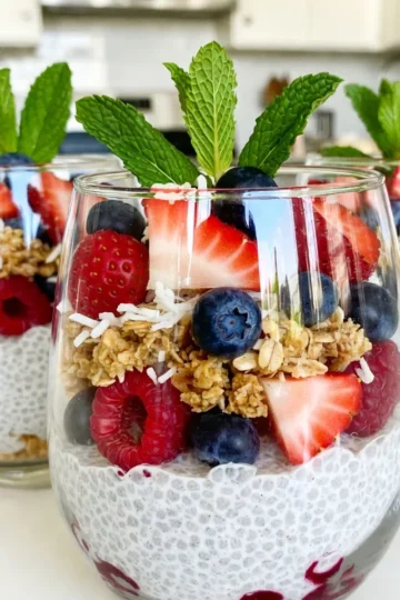 - 1 cup coconut milk - ¼ cup chia seeds - 2 tablespoons honey or maple syrup - 1 teaspoon vanilla extract - 1 cup mixed berries (strawberries, blueberries, raspberries) - ¼ cup granola - 2 tablespoons shredded coconut - Fresh mint leaves for garnish (optional) - Coconut milk: This creamy milk is rich in healthy fats. It offers energy and helps keep you full longer. - Chia seeds: These tiny seeds are packed with fiber. They aid digestion and help you stay satisfied. - Honey or maple syrup: Both are natural sweeteners. They provide quick energy and have antioxidants. - Vanilla extract: This adds flavor and can have calming effects. It makes the parfait taste wonderful. - Mixed berries: Berries are high in vitamins and low in calories. They support heart health and are full of antioxidants. - Granola: This crunchy topping gives energy and can contain oats and nuts. It adds texture and helps keep you full. - Shredded coconut: It adds flavor and healthy fats. Coconut also brings a delightful chewiness. - Fresh mint leaves: These are optional but refreshing. They can enhance the taste and look of your parfait. - Coconut milk: Use almond milk or oat milk for a nut-free option. - Chia seeds: You can swap them with flax seeds, but adjust the liquid. - Honey: For a vegan option, use agave syrup or more maple syrup. - Granola: Choose gluten-free granola if needed, or use oats. - Mixed berries: Any seasonal fruit works well. Try peaches or apples for a change. {{ingredient_image_2}} To start, gather your ingredients. You will need 1 cup of coconut milk, ¼ cup of chia seeds, 2 tablespoons of honey or maple syrup, and 1 teaspoon of vanilla extract. 1. In a medium bowl, pour in the coconut milk. 2. Add the chia seeds, honey, and vanilla extract. 3. Whisk until everything mixes well. 4. Cover the bowl with plastic wrap or a lid. 5. Place it in the fridge for at least 4 hours or overnight. This waiting time lets the chia seeds absorb the milk. They will turn into a creamy pudding. Once your chia pudding is ready, it&rsquo;s time to layer your parfait. You will need 1 cup of mixed berries, ¼ cup of granola, and 2 tablespoons of shredded coconut. 1. Take your serving glasses or mason jars. 2. Spoon a layer of chia pudding into each glass. Fill about ¼ of the glass. 3. Add a layer of mixed berries on top. Use a mix of strawberries, blueberries, and raspberries for color. 4. Sprinkle some granola over the berries for a nice crunch. 5. Repeat the layers: more chia pudding, more berries, and more granola. 6. Finish with a vibrant layer of berries on top. 7. Sprinkle shredded coconut over the final layer. This adds flavor and makes the parfait look even better. For the best presentation, serve your parfaits in clear glasses. This lets everyone see the colorful layers. You can add fresh mint leaves on top for a pop of color. If you want extra sweetness, drizzle a little honey over the top just before serving. Enjoy your tasty and healthy parfait! To get that ideal chia texture, start with the right ratio. Use ¼ cup of chia seeds for every cup of coconut milk. Mix them well. Let the mix rest for at least four hours. This allows the chia seeds to soak up the milk and thicken. If you want it creamier, try letting it chill overnight. This step is key for a smooth, pudding-like consistency. To make your parfait look beautiful, use clear glasses or mason jars. This way, you can show off the layers. Start with a layer of chia pudding, then add mixed berries. Next, sprinkle on granola for crunch. Repeat this layering until the glass is full. Finish with a top layer of colorful berries. For extra flair, add shredded coconut and fresh mint leaves. These touches make your parfait pop and look inviting. You can sweeten your parfait with honey or maple syrup. Each option brings a unique flavor. Honey gives a floral note, while maple syrup adds a rich, earthy taste. If you prefer a vegan option, stick with maple syrup. Both sweeteners work well, so choose what you like best. Just use two tablespoons for the right sweetness without overpowering the dish. Pro Tips Chill Time is Key: Allowing the chia pudding to chill overnight ensures it reaches the perfect creamy consistency, making each bite delightful. Berry Variety: Using a mix of berries not only adds flavor but also contributes to a beautiful and colorful presentation. Granola Texture: Choose a granola with a mix of nuts and seeds for added crunch and nutrition, enhancing the overall texture of the parfait. Garnish for Appeal: Fresh mint leaves not only add a pop of color but also a refreshing aroma, elevating the visual and taste experience of your parfait. {{image_4}} You can change the berries based on the season. In spring or summer, use fresh strawberries and blueberries. Fall brings sweet raspberries and cranberries. In winter, consider frozen berries. They still taste great and add color. Mixing different berries also boosts flavor and nutrition. Experiment to find your favorite berry blend. Coconut milk is creamy and delicious, but you can try others. Almond milk offers a light taste. Oat milk adds a hint of sweetness. Soy milk gives a protein boost. Each milk changes the flavor and texture. Pick one that suits your taste or diet. This way, you can enjoy the parfait your way. You can add more to the parfait to make it unique. Consider nuts like almonds or walnuts for crunch. Seeds such as pumpkin or sunflower add nutrition. You might enjoy spices like cinnamon or nutmeg for warmth. A spoonful of peanut or almond butter gives creaminess. These add-ins enhance both taste and texture, making each bite exciting. Store your Berry Coconut Chia Parfait in the fridge. Use airtight containers to keep it fresh. The cool air helps maintain its creamy texture and flavor. Avoid sunlight, as it can affect taste and color. You can keep the chia pudding for up to five days. After that, the texture may change and lose its quality. Always check for any off smells or changes before eating. If you notice any, it&rsquo;s best to throw it away. To keep your parfait layers fresh, store them separately if possible. This way, the granola stays crunchy. If you layer and store together, the granola might get soggy. Serve the parfait within a day for the best taste. Enjoy your treat while it's fresh! Yes, you can make this parfait ahead of time. In fact, it's great to prepare it the night before. The chia seeds need time to soak in the coconut milk. A few hours in the fridge works, but overnight is best. This way, the pudding gets thick and creamy. You can layer it and keep it in the fridge for up to three days. Just wait to add the granola until you're ready to eat. This keeps it crunchy. Chia seeds are tiny black seeds from the Salvia hispanica plant. They are packed with nutrients. Here are some key benefits: - High in Fiber: Helps with digestion and keeps you full. - Rich in Omega-3 Fatty Acids: Good for heart health. - Good Source of Protein: Supports muscle health. - Full of Antioxidants: Helps fight free radicals. - Minerals: Contains calcium, magnesium, and iron. These seeds absorb liquid and expand, making them perfect for puddings. They create a fun texture in your parfait. Yes, you can use frozen berries! They work well in this parfait. Just remember: - Thaw Them: Let them sit at room temperature or microwave them for a few seconds. - Flavor: Frozen berries may be sweeter since they are picked at peak ripeness. - Texture: They can be softer, but they still taste great. Using frozen berries is a smart choice. It allows you to enjoy this treat all year round! This blog covered how to make a delicious Berry Coconut Chia Parfait. We looked at the key ingredients and their health benefits. I shared step-by-step instructions to prepare the pudding and layer it nicely. You learned tips for perfect texture and stunning presentation. Plus, we explored tasty variations and storage tips to keep it fresh. In the end, making this parfait is fun and rewarding. You can customize it to suit your taste and needs. Enjoy your healthy treat!