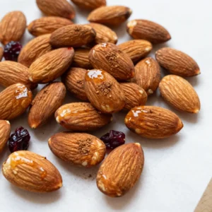- 2 cups raw almonds - ¼ cup pure maple syrup - 1 tablespoon ground cinnamon - ¼ teaspoon fine sea salt - ½ teaspoon pure vanilla extract - 1 tablespoon coconut oil (or olive oil) - Optional: ¼ cup dried cranberries or raisins To make maple cinnamon roasted almonds, gather these simple ingredients. The key is raw almonds. They provide a nice crunch and absorb the sweet flavors well. Pure maple syrup adds a rich sweetness. Ground cinnamon gives warmth and spice. Fine sea salt enhances the flavors. The vanilla extract adds depth, while coconut oil helps the glaze stick. If you want a fruity twist, toss in some dried cranberries or raisins. They make the snack even better. When you have everything ready, you&rsquo;ll create a tasty treat everyone will love! {{ingredient_image_2}} - Set oven temperature to 350&deg;F (175&deg;C). - Line baking sheet with parchment paper. - Combine maple syrup, cinnamon, salt, vanilla extract, and oil. - Whisk until smooth and well incorporated. To make the glaze, you need to mix the maple syrup, ground cinnamon, fine sea salt, pure vanilla extract, and coconut oil in a bowl. This mix adds a sweet and warm flavor. It will coat the almonds and make them taste amazing. - Add raw almonds into the glaze. - Stir gently to ensure even coating. Next, add the raw almonds to the glaze. Stir them gently so every almond gets a nice coat. This step is key for great flavor. - Spread coated almonds on a baking sheet in a single layer. - Roast for 15-20 minutes, stirring halfway. Now, pour the almonds onto the baking sheet. Spread them out into a single layer. This helps them roast evenly. Roast the almonds for about 15 to 20 minutes. Stir them halfway through. This keeps them from burning and helps each almond get golden brown. - Remove from oven when golden brown. - Allow cooling before adding dried cranberries or raisins. Once the almonds are golden brown, take them out of the oven. Let them cool on the baking sheet. As they cool, they will become crunchy. If you want to add dried cranberries or raisins for some sweetness, do it now. Mix them in after the almonds have cooled. Enjoy your maple cinnamon roasted almonds as a snack, or use them on yogurt or salads! To get the best flavor, monitor your almonds closely while they roast. Ovens can be tricky, and almonds can burn quickly. Stir the almonds halfway through roasting. This helps them brown evenly and keeps them from getting too dark. Feel free to swap almonds for other nuts like walnuts or pecans. Each nut brings its own unique taste. You can also mix in spices. Try adding nutmeg or cardamom for a twist. For a bit of heat, add a pinch of cayenne pepper. This small change can elevate the flavor. If you want extra sweetness, drizzle some maple syrup on top after roasting. This adds a delightful finish to your almonds. Pro Tips Use Fresh Ingredients: Always opt for fresh, high-quality almonds and pure maple syrup to enhance the flavor of your roasted almonds. Monitor Cooking Time: Ovens can vary, so keep a close eye on the almonds during roasting to prevent burning. Stir them halfway through for even cooking. Cool Completely: Allow the almonds to cool completely on the baking sheet; they will continue to harden as they cool, resulting in the perfect crunchy texture. Experiment with Flavors: Feel free to experiment with other spices like nutmeg or add a pinch of cayenne pepper for a spicy kick along with the sweetness. {{image_4}} You can switch up the nuts in this recipe. Try using pecans or walnuts instead of almonds. Mixed nuts also work well. Each nut brings its own flavor and texture. Pecans add a buttery taste, while walnuts have a slight bitterness. Experiment with what you love! Adjust the sweetness to suit your taste. If you want it sweeter, add more maple syrup. You can also mix in some brown sugar. It gives a nice caramel-like flavor. Just remember to balance the sweetness with the salt. You can change the flavor each season. In fall, add pumpkin spice for a warm touch. It gives a cozy, festive vibe. For a dessert feel, drizzle some melted chocolate on top. This adds a rich sweetness that pairs well with the nuts. Enjoy making these simple changes! - Use an airtight container for freshness. - Store in a cool, dry place. I recommend placing your maple cinnamon roasted almonds in an airtight container. This helps keep them fresh and crunchy. A glass jar or a plastic container works well. Make sure it closes tightly. Keep the container in a cool, dry place. Avoid sunny spots or areas with high humidity. Heat and moisture can make your almonds spoil faster. Your pantry or a cupboard are great options. - Duration of freshness at room temperature vs refrigerator. - Signs of spoilage to look out for. At room temperature, your roasted almonds should last about two weeks. If you want them to last longer, place them in the refrigerator. They can stay fresh for up to a month there. Look for signs of spoilage. If the almonds smell bad or taste bitter, they are no longer good. You might also see mold or a change in color. If you notice any of these signs, it's time to toss them. Keeping your almonds fresh is key to enjoying this tasty snack! Yes, you can use roasted almonds. However, they may not absorb the glaze as well as raw almonds. Raw almonds offer a fresher taste and keep the crunch after roasting. Almonds are done when they turn golden brown and release a sweet aroma. Stir them halfway through roasting to ensure even cooking. Keep a close eye on them to prevent burning. Yes, they are a healthy snack! Almonds provide protein, fiber, and healthy fats. The maple syrup adds natural sweetness without refined sugars. Enjoy them in moderation for a guilt-free treat. These almonds pair well with yogurt, oatmeal, or salads. You can also enjoy them as a snack on their own. Adding them to trail mix is another tasty option. Absolutely! You can make them a few days in advance. Store them in an airtight container to keep them fresh. Enjoy the convenience of having a delicious snack ready to go! You now know how to make maple cinnamon roasted almonds with simple steps and tips. The main ingredients are raw almonds, pure maple syrup, and cinnamon. Adjust the sweetness to your liking and try different nuts for variety. Remember to store them in an airtight container. Enjoy these delicious snacks as a healthy treat or add them to your favorite dishes. Experiment with flavors and have fun while making them! Your new snack is sure to please.